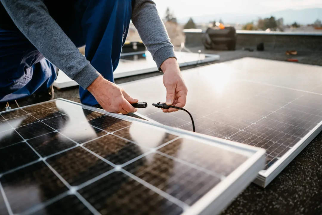 Man working on solar energy system.